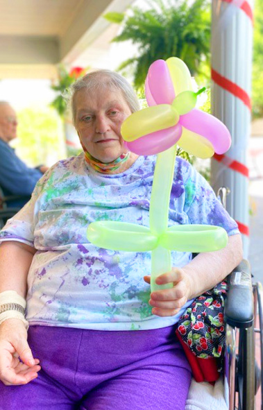 Morganfield Nursing and Rehab resident holding balloon flower