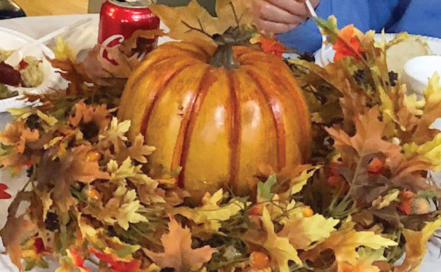 Fall pumpkin center piece with leaves