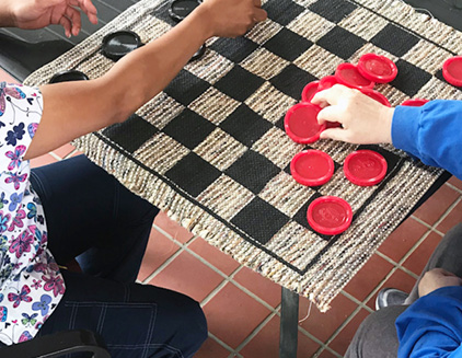 Morganfield residents playing checkers outdoors