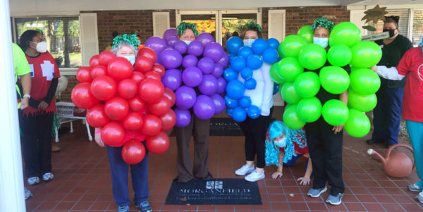 Morganfield staff dressed as grapes using balloons