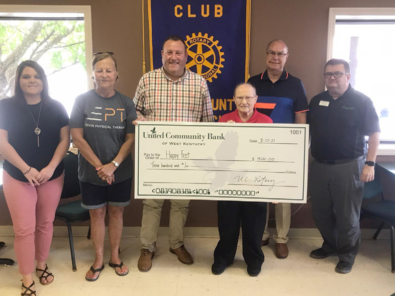 group of men and women holding large check, donation made by Union County Rotary
