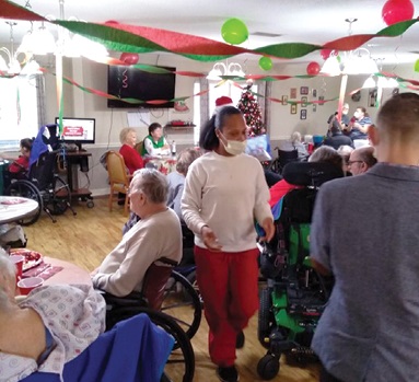 action photo of residents and staff mingling during holiday party