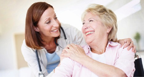 young female doctor smiling with senior woman