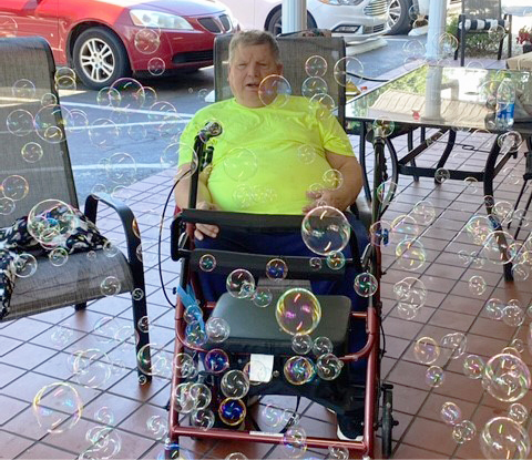 Man in wheel chair enjoying bubbles during Morganfield Nursing and Rehab Bubble Day