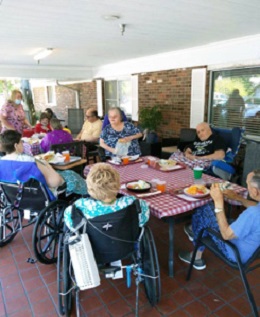 residents of Morganfield enjoying sub sandwiches on the porch together
