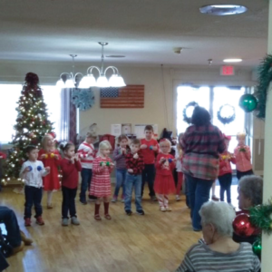 group of young children putting on Christmas Bell performance