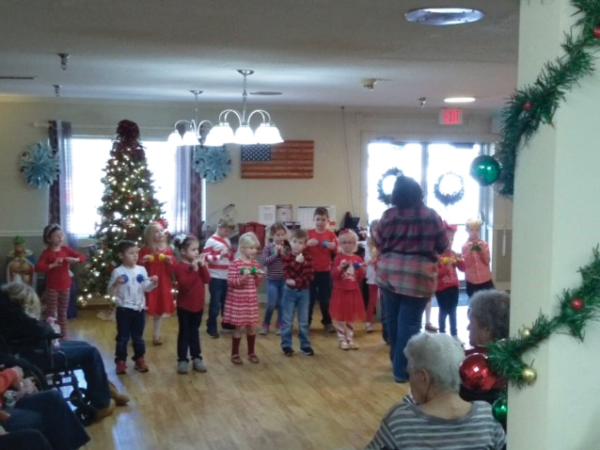 group of young children putting on Christmas Bell performance