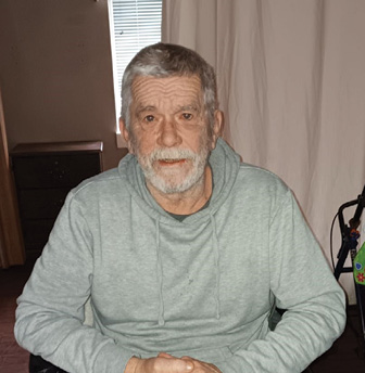 Older man, resident of Morganfield Nursing and Rehab, sitting in his room for photo